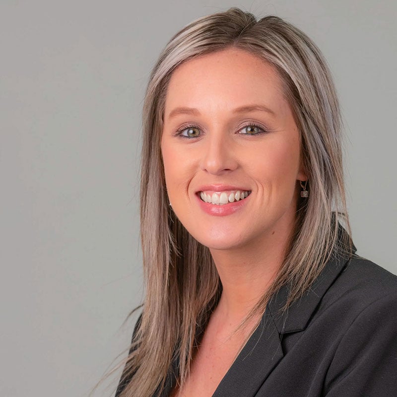a woman with long hair and a black blazer