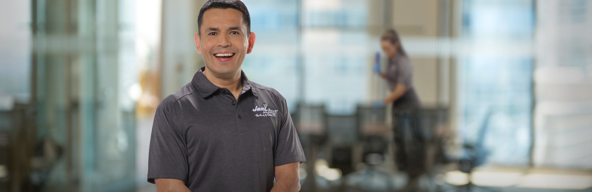 a man in a gray shirt is smiling