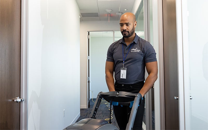 a man in a black shirt is standing in a hallway