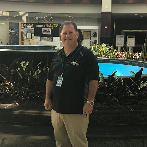 a man standing in front of a pool