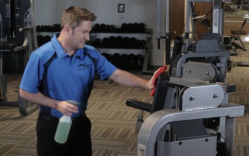 Cleaner at the gym wiping