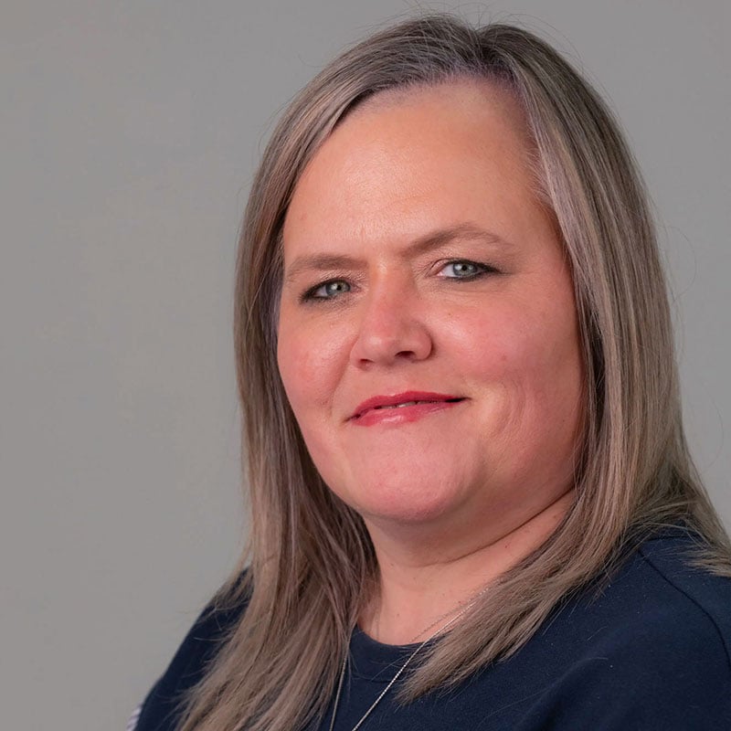 a woman with long hair and blue shirt