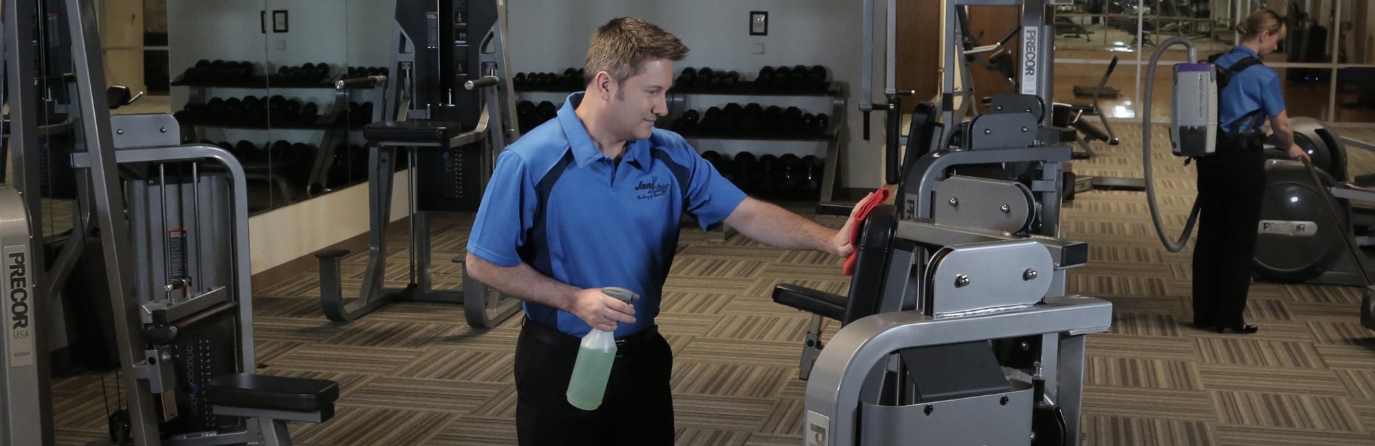 a cleaning employee working on cleaning a gym