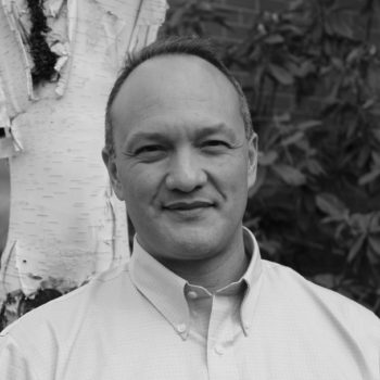 a man standing in front of a tree