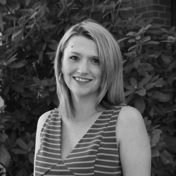 a woman in a striped dress sitting on a bench