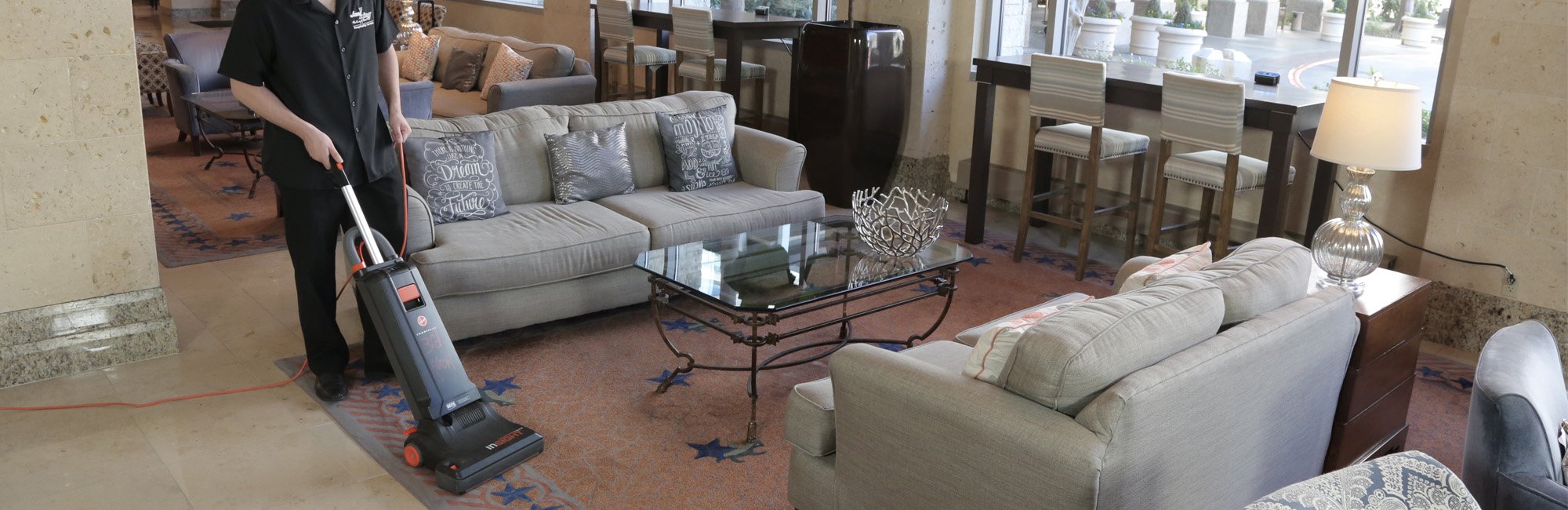 Person vacuuming hotel lobby