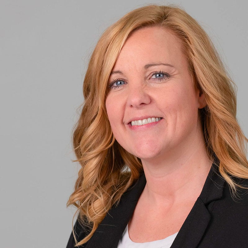 a woman with blonde hair and a black jacket