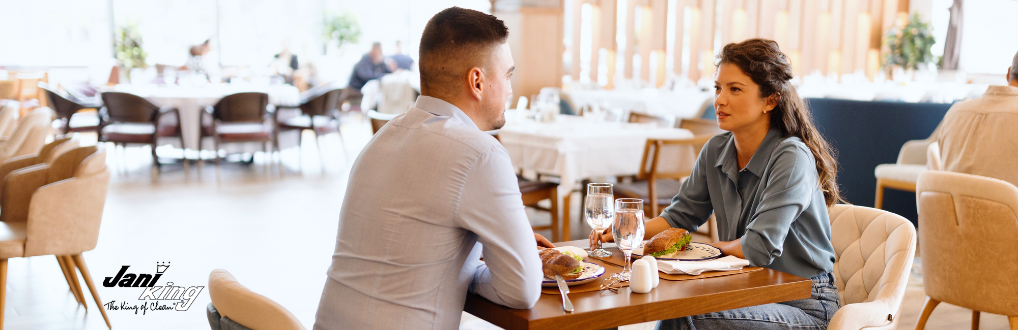 Couple enjoying their meal in a clean restaurant.
