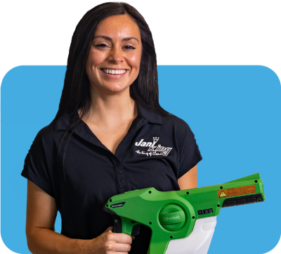 a woman holding a green and white blower providing building cleaning services