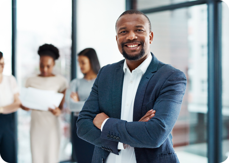 a man in a suit standing with his arms crossed