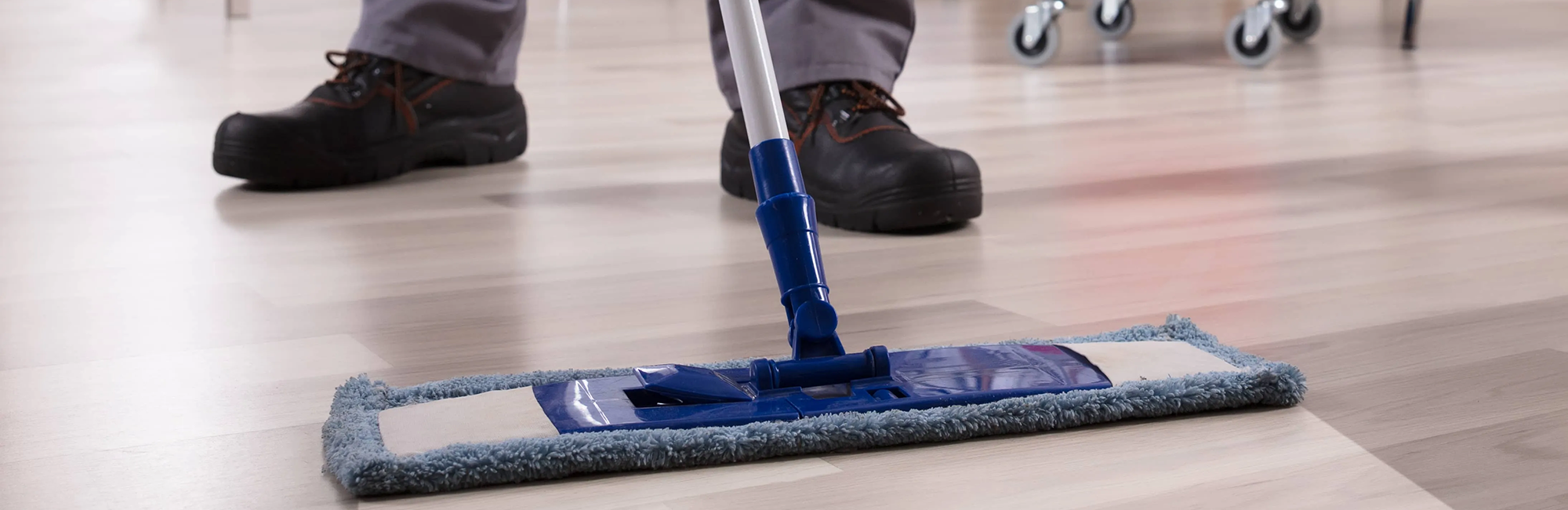 Cleaning employee mopping the hardwood floor